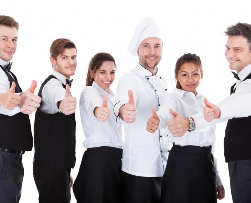 Waiters and waitresses showing thumbs up sign