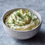 Selleriepüree in einer minimalistischen Keramikschale, cremige Textur, mit Kräutern bestreut, weiches natürliches Licht, skandinavisches Food-Styling.